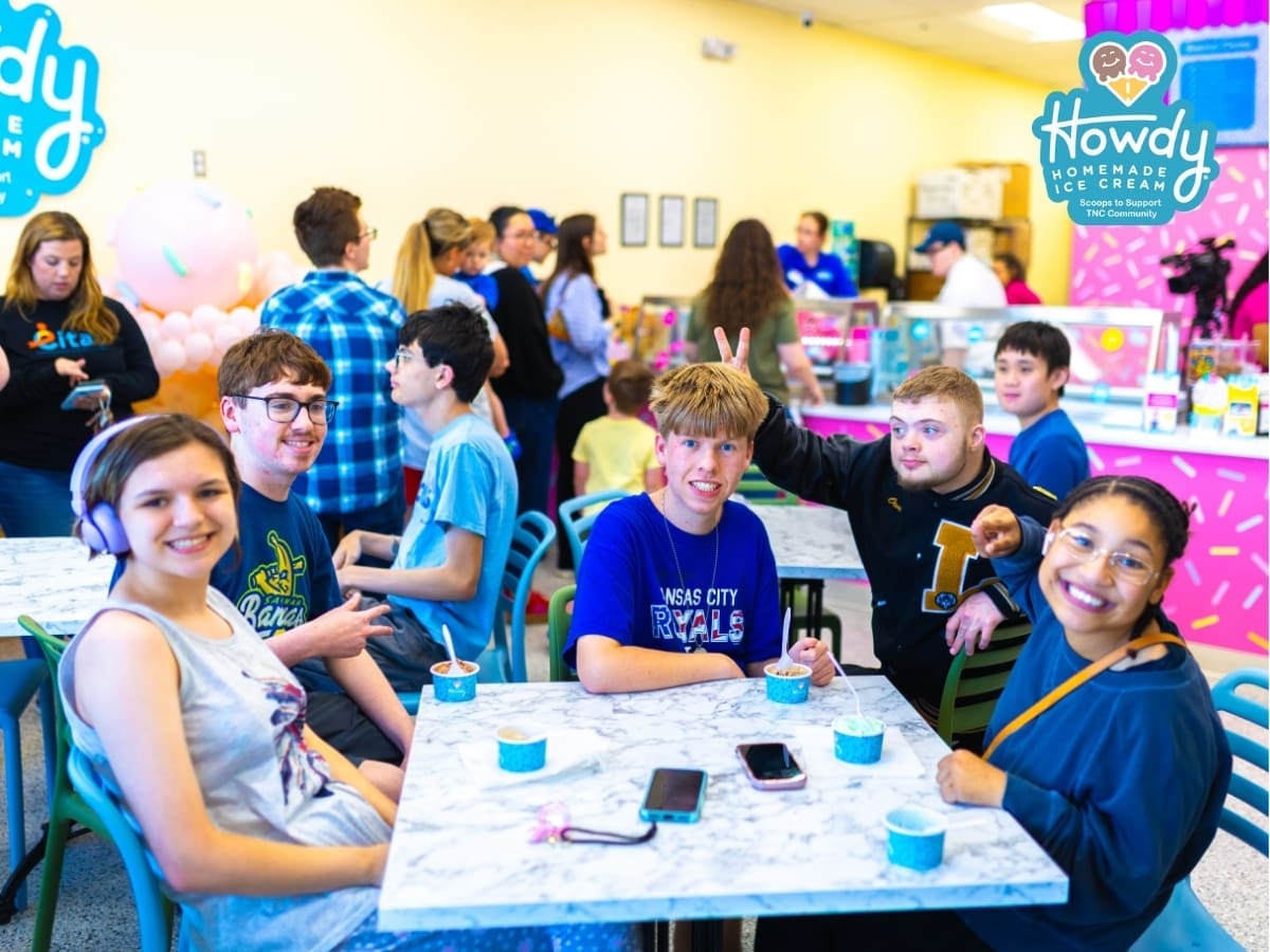 Howdy Homemade Ice Cream shop interior with a group of young guests enjoying their scoops together